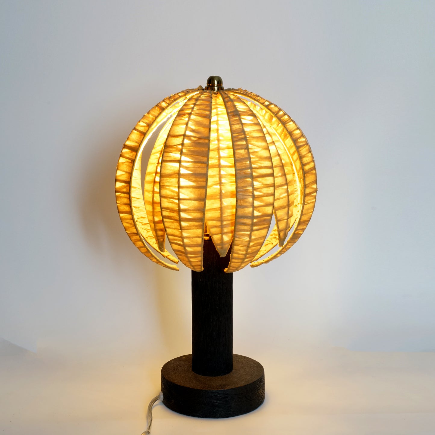 Decorative table lamp with a unique design on a plain background