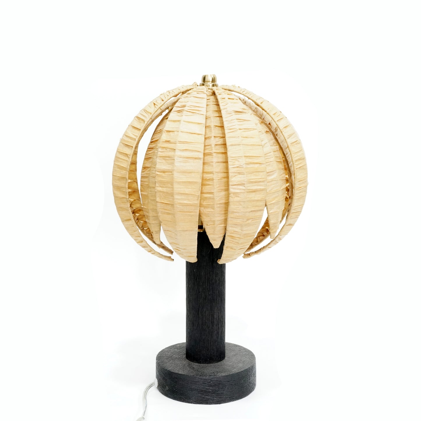 Decorative lamp with wicker shade and black base on a white background