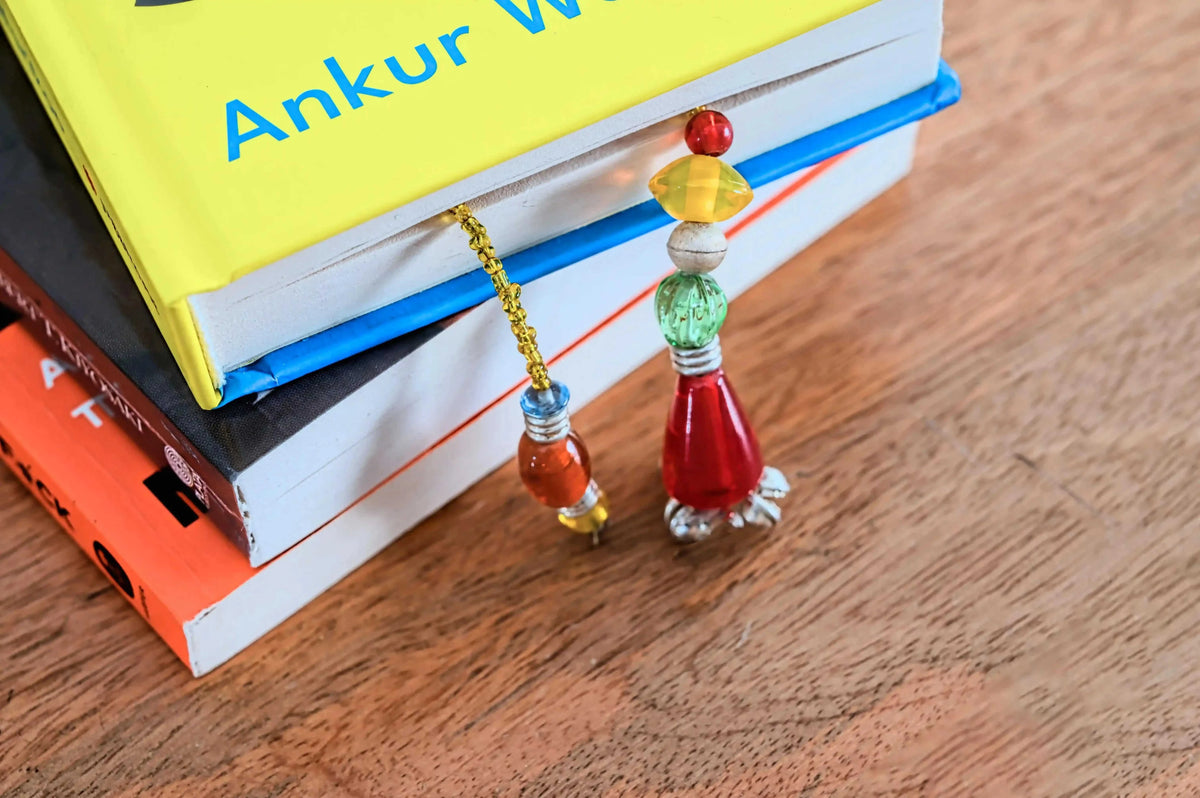 Yellow glass beads handmade bookmark by ILLUMEA on a book page