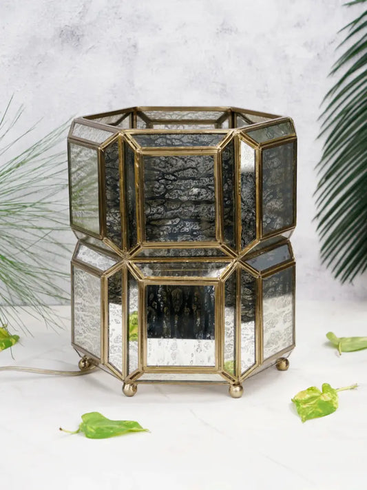 Hexagonal glass container with gold accents on a light background