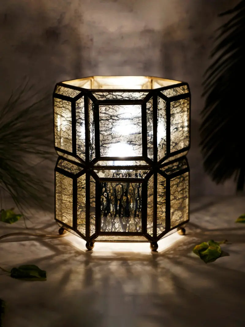 Decorative hexagonal lantern with a warm glow on a dark background