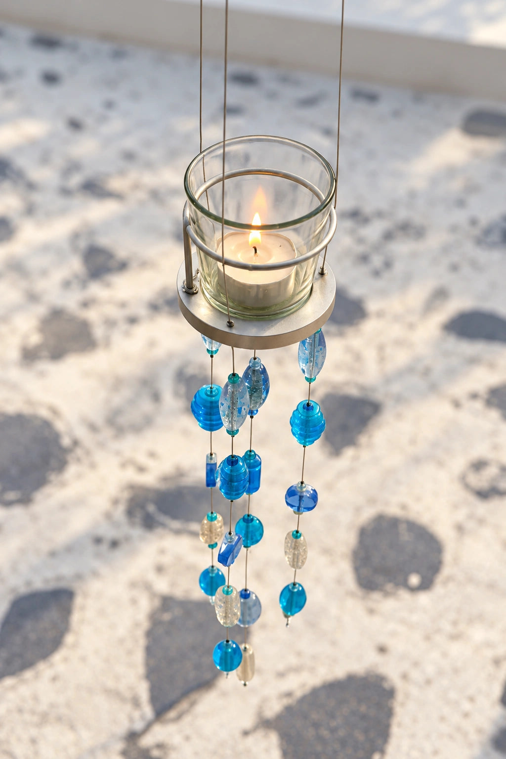 Turquoise Blue Glass Beaded Candle Holder – ILLUMEA hanging votive lantern with translucent glass beads in blue and aqua tones, designed for stylish indoor and outdoor decoration