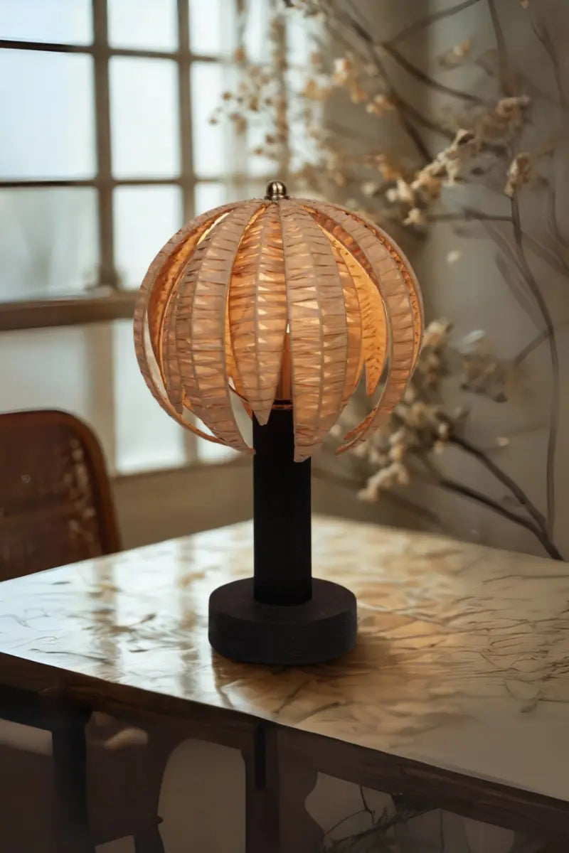 Decorative table lamp with a spherical design on a marble surface.