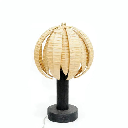 Decorative lamp with woven beige shade and black base on a white background
