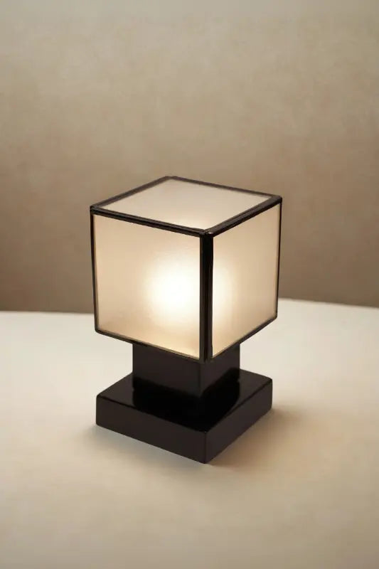 Table lamp with a square shade on a neutral background