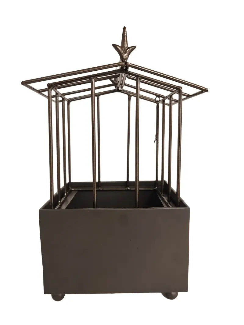 Decorative metal planter with a star-like top on a white background