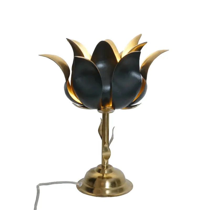 Decorative table lamp with black and gold floral design on a white background