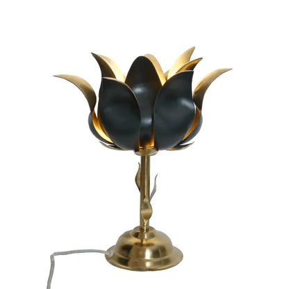 Decorative table lamp with black and gold floral design on a white background