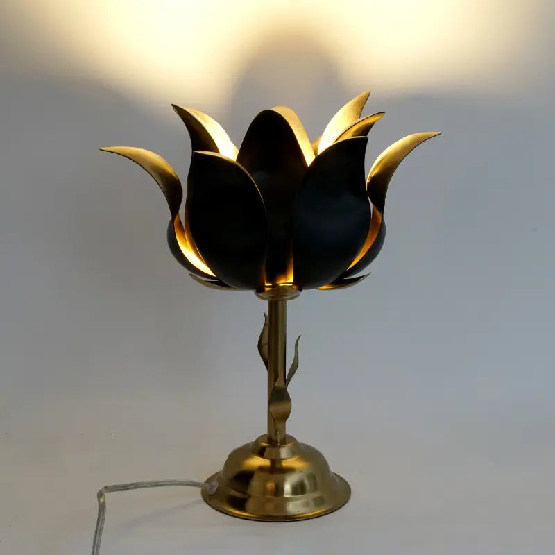 Decorative lamp with gold and black design on a plain background