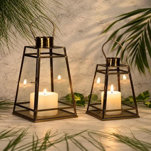 ILLUMEA Geometric Antique Glass Lantern featuring a tapered square frame, brass finish and clear glass panels, ideal for premium residential and hospitality décor.