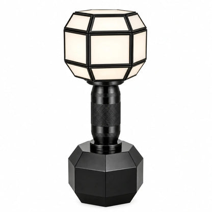 Modern geometric Dumble table lamp by ILLUMEA featuring a faceted shade, textured stem and sculptural black base