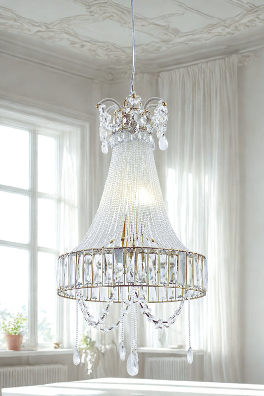 A luxurious crystal glass chandelier with a fluted glass body and hanging crystal beads, displayed in a bright room setting.
