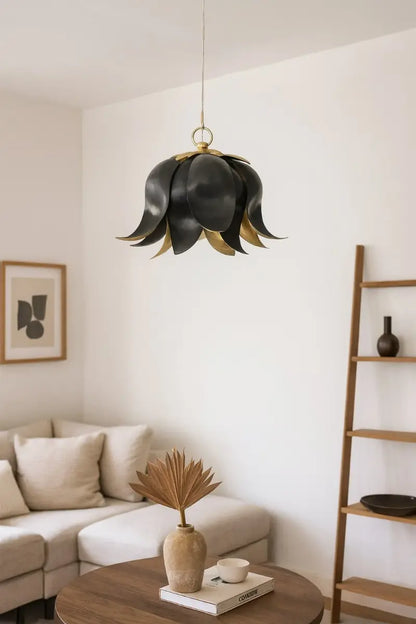 Modern living room with a unique black and gold pendant light fixture.