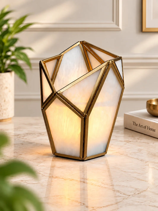 Geometric Tealight Candle Holder – ILLUMEA luxury decorative lantern featuring frosted white glass panels and an intricate brass geometric frame for elegant home décor