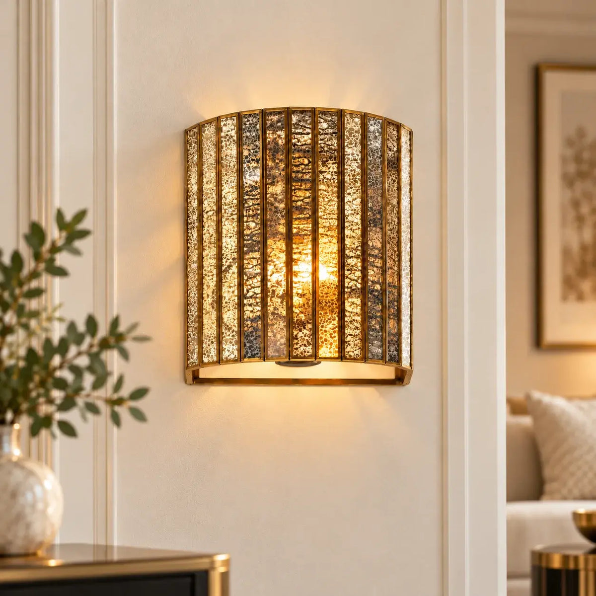 Brass luxury wall lamp featuring silver antique glass, elegant lighting fixture by ILLUMEA for sophisticated interiors